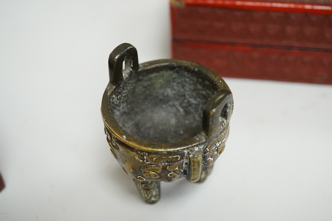 Two Chinese cinnabar lacquer boxes and a Chinese archaistic miniature bronze tripod censer, rectangular lacquer box 11.5cm high x 7.5cm deep